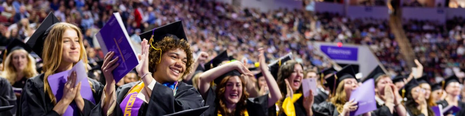 students cheering at graduation
