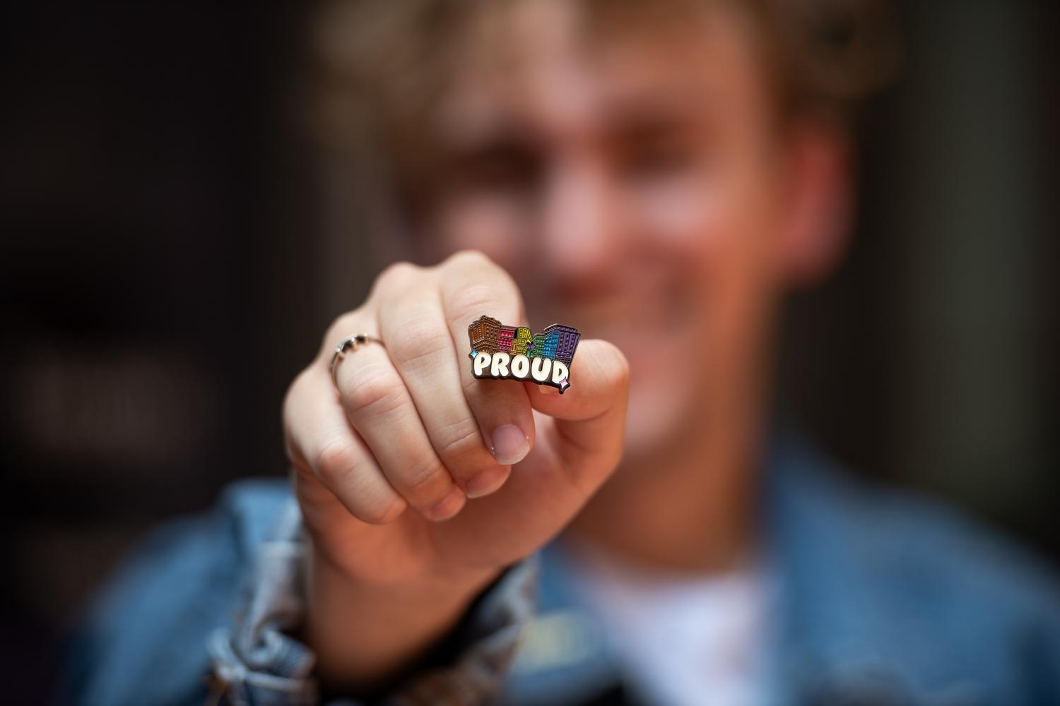 Student holding Pride pin