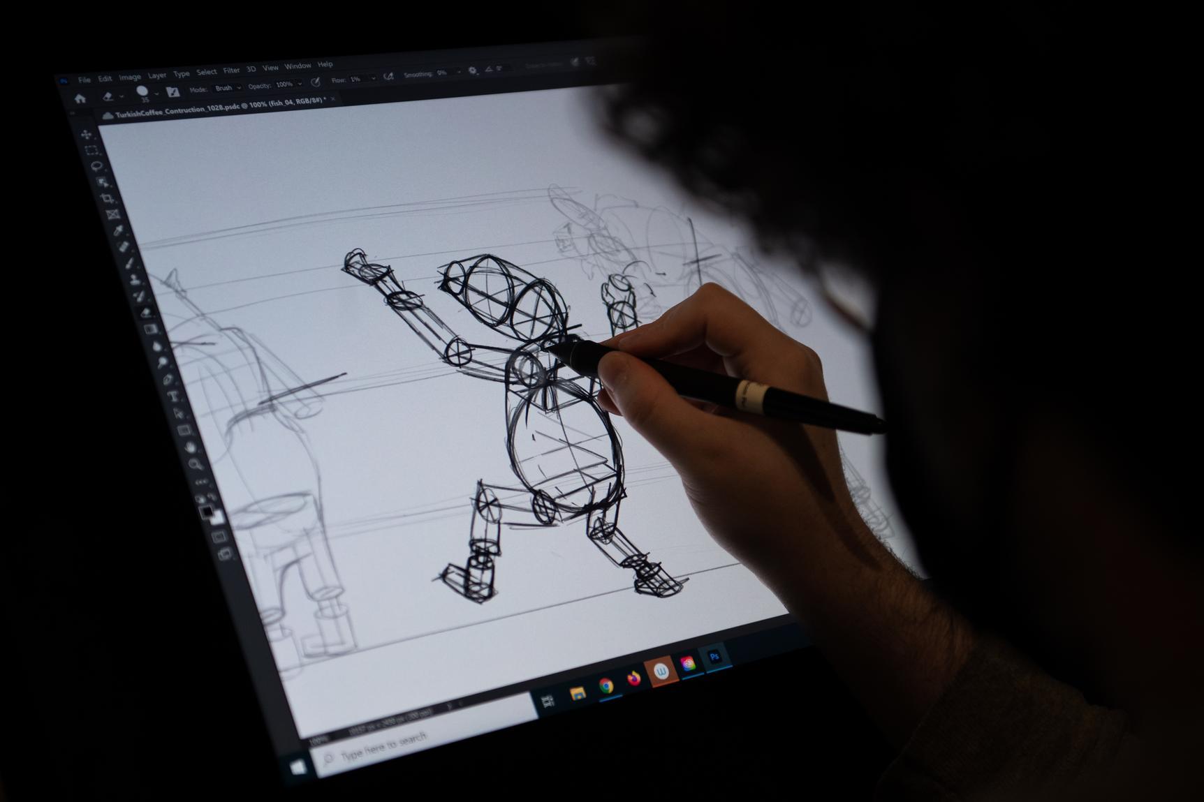 A student drawing a digital illustration a tablet