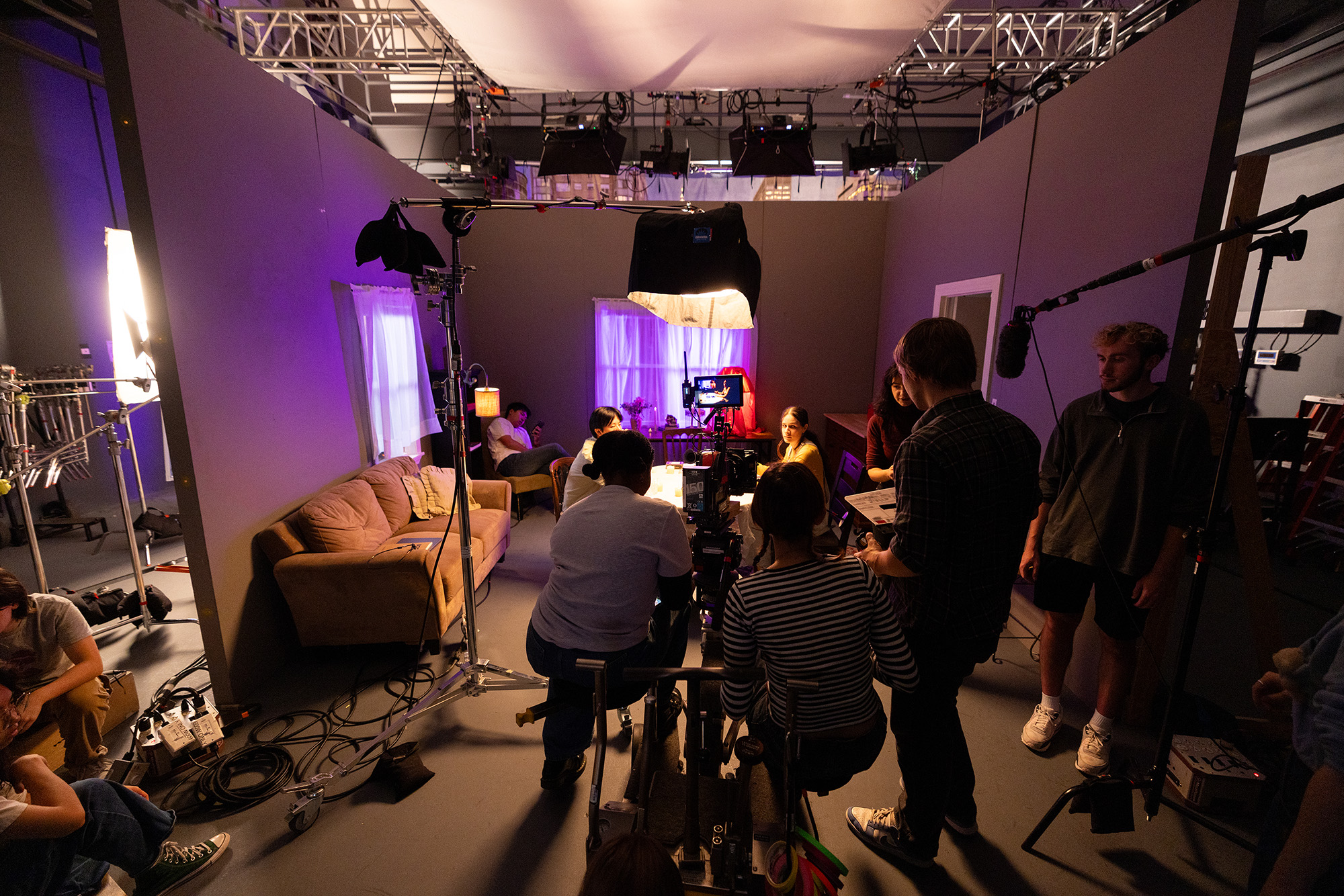 Students on set for a cinematography class, doing hands-on staging